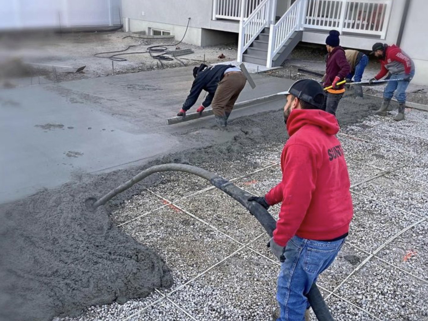 Crew managing concrete placement with pump equipment
